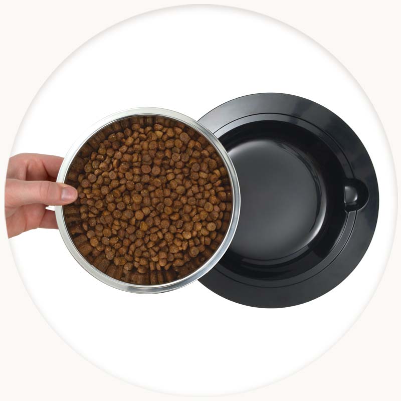 Hand lifting the stainless steel bowl out of the Zeus Oasis Food Bowl