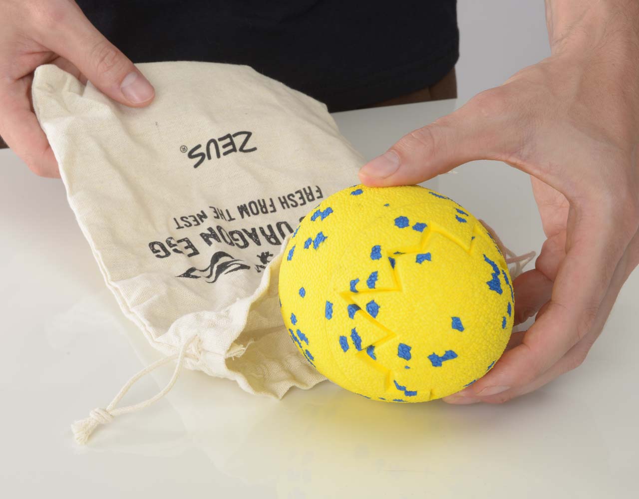 Hand taking the Zeus NITRO Dragon Egg out of its bag.