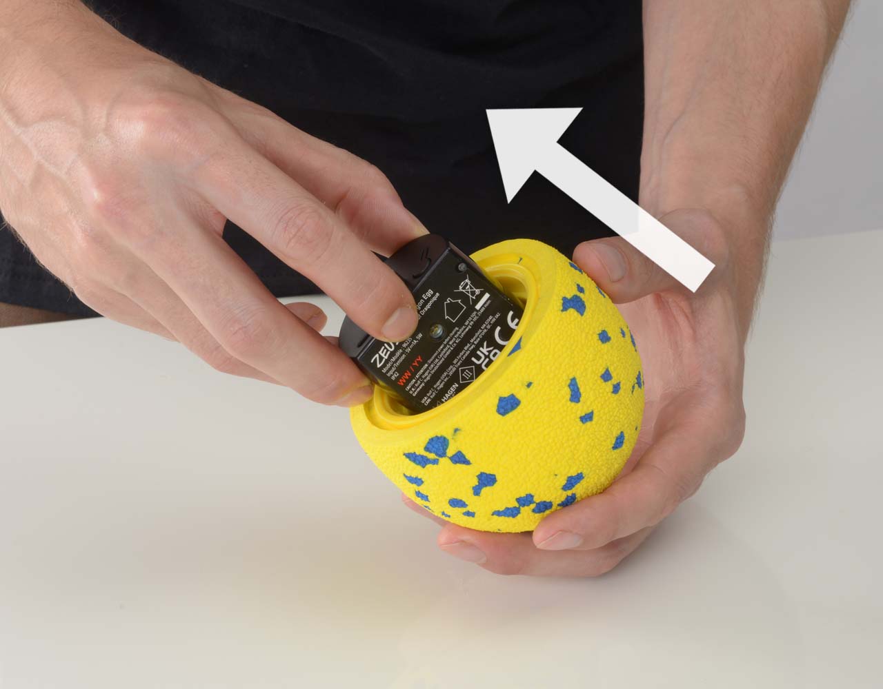 Hand taking the Zeus NITRO Dragon Egg motor hub out of the shell.
