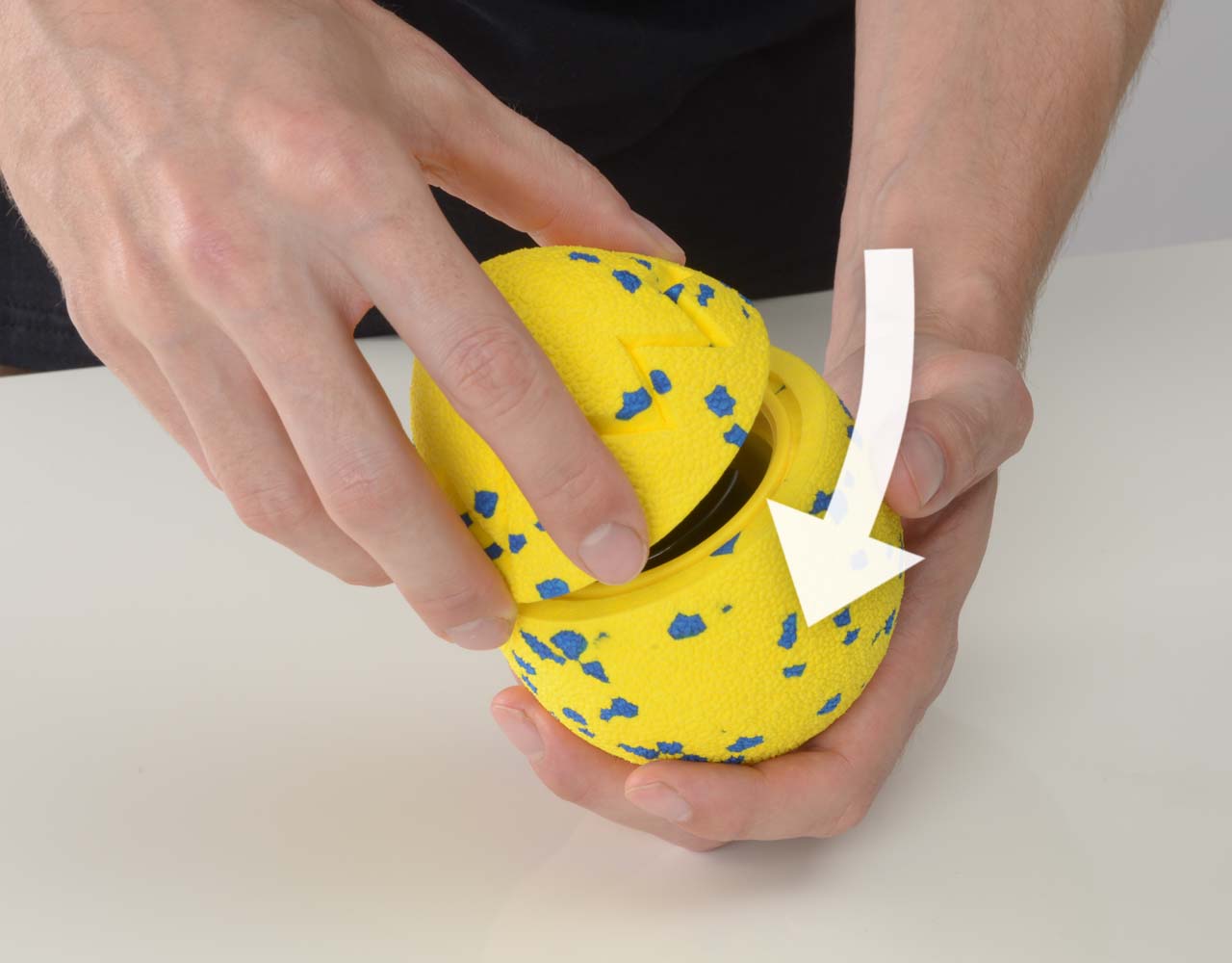 Hand twisting the top part of the Zeus NITRO Dragon Egg on the base of the outer shell.
