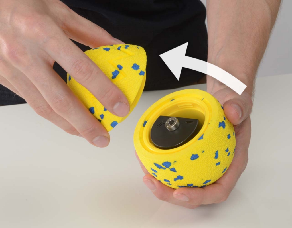 Hand unscrewing the top of the Zeus NITRO Dragon Egg.