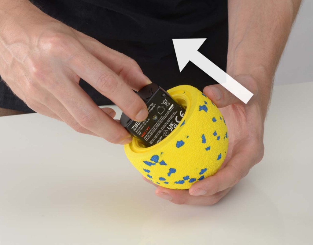 Hand taking the Zeus NITRO Dragon Egg motor hub out of the shell.